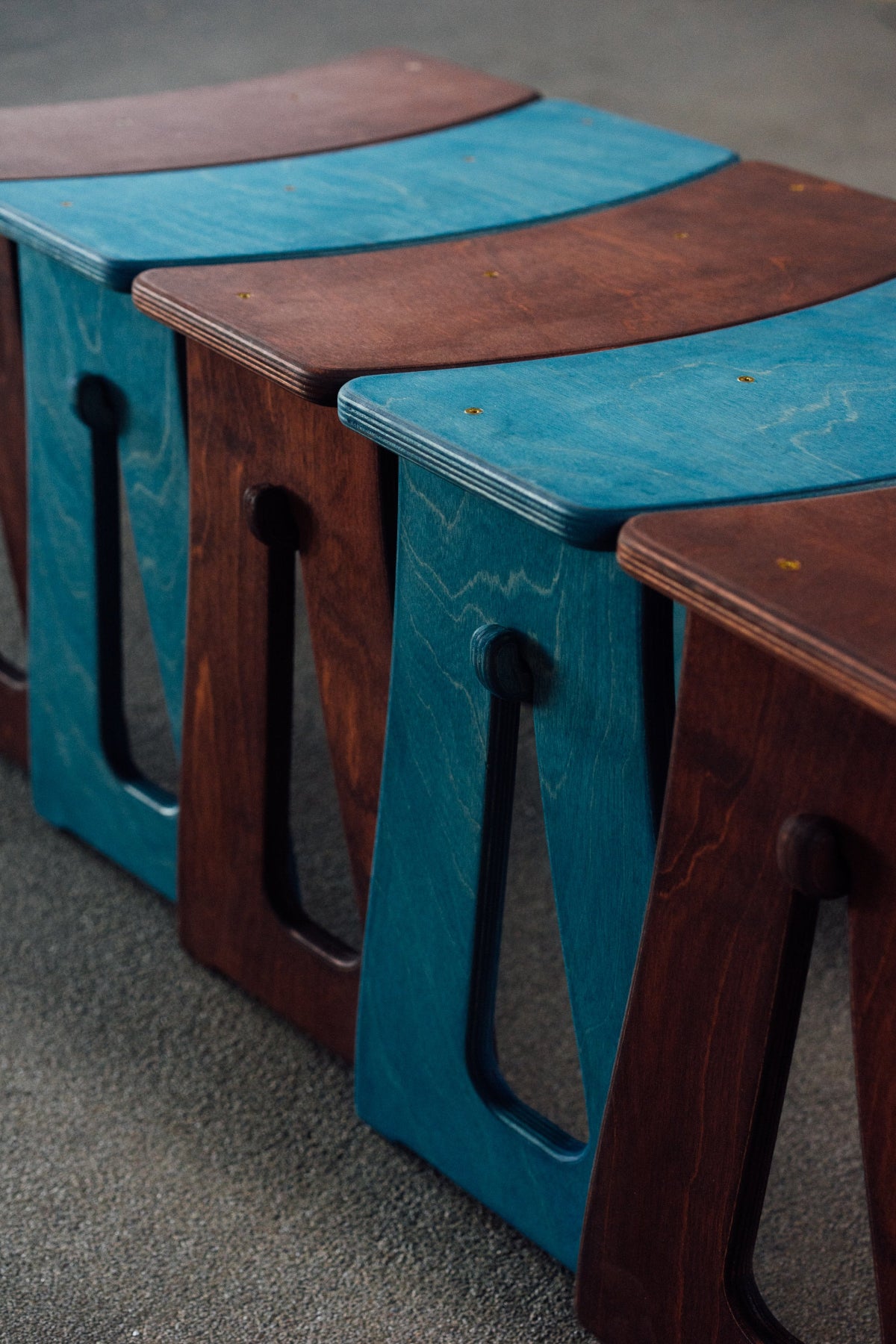 Set of wooden stools in brown and blue.