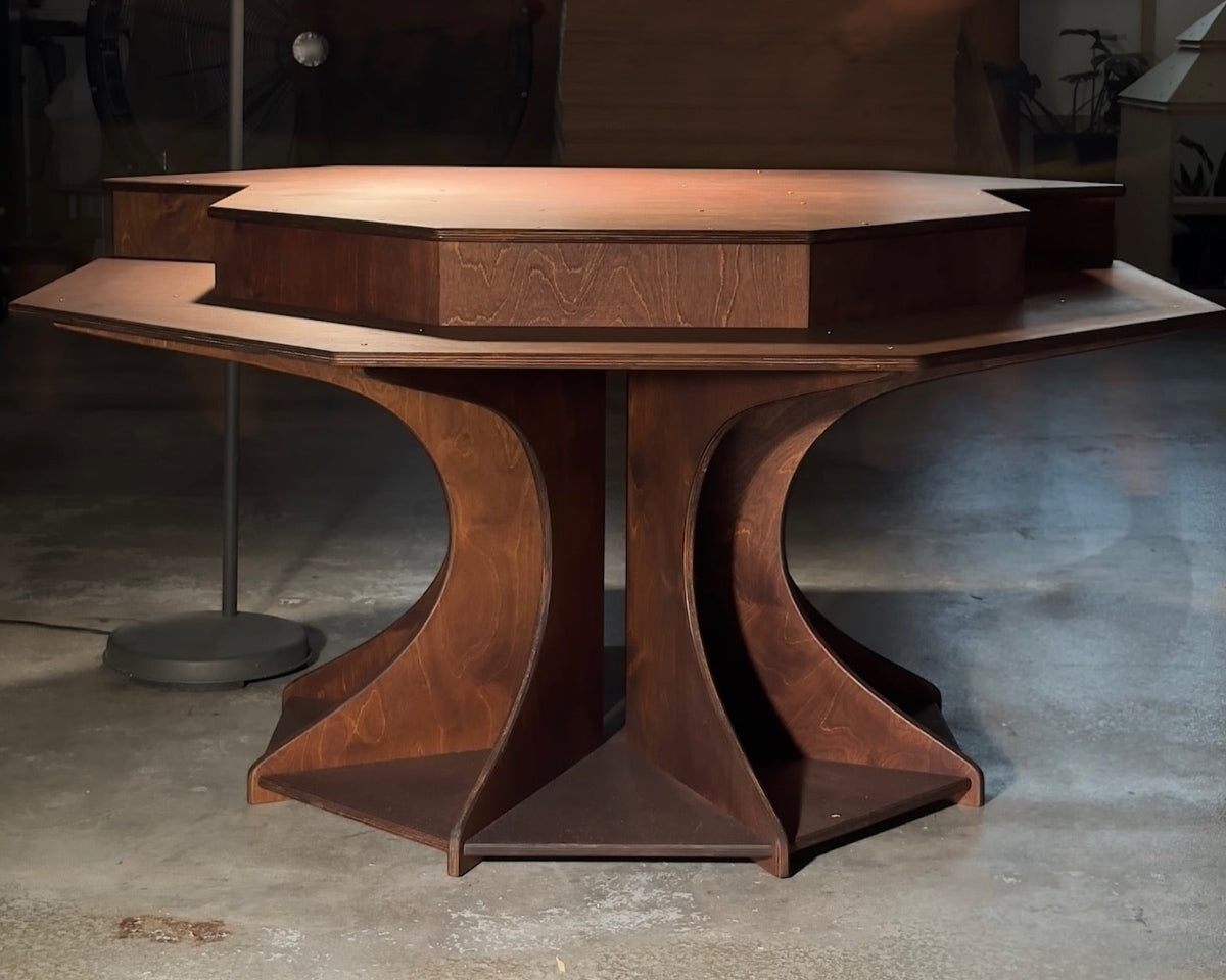 Wooden table with a unique design for multi-player RPGs in an indoor setting